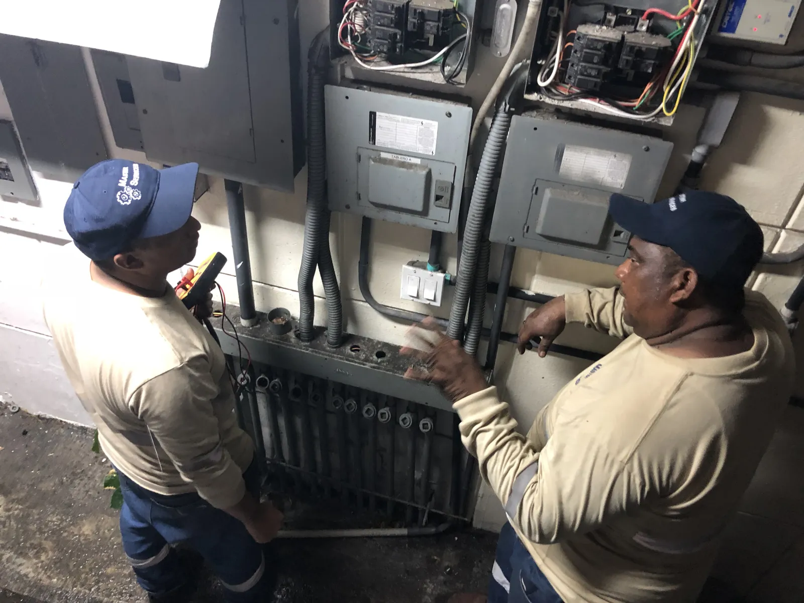 Técnicos trabajando en el tablero eléctrico de la estación